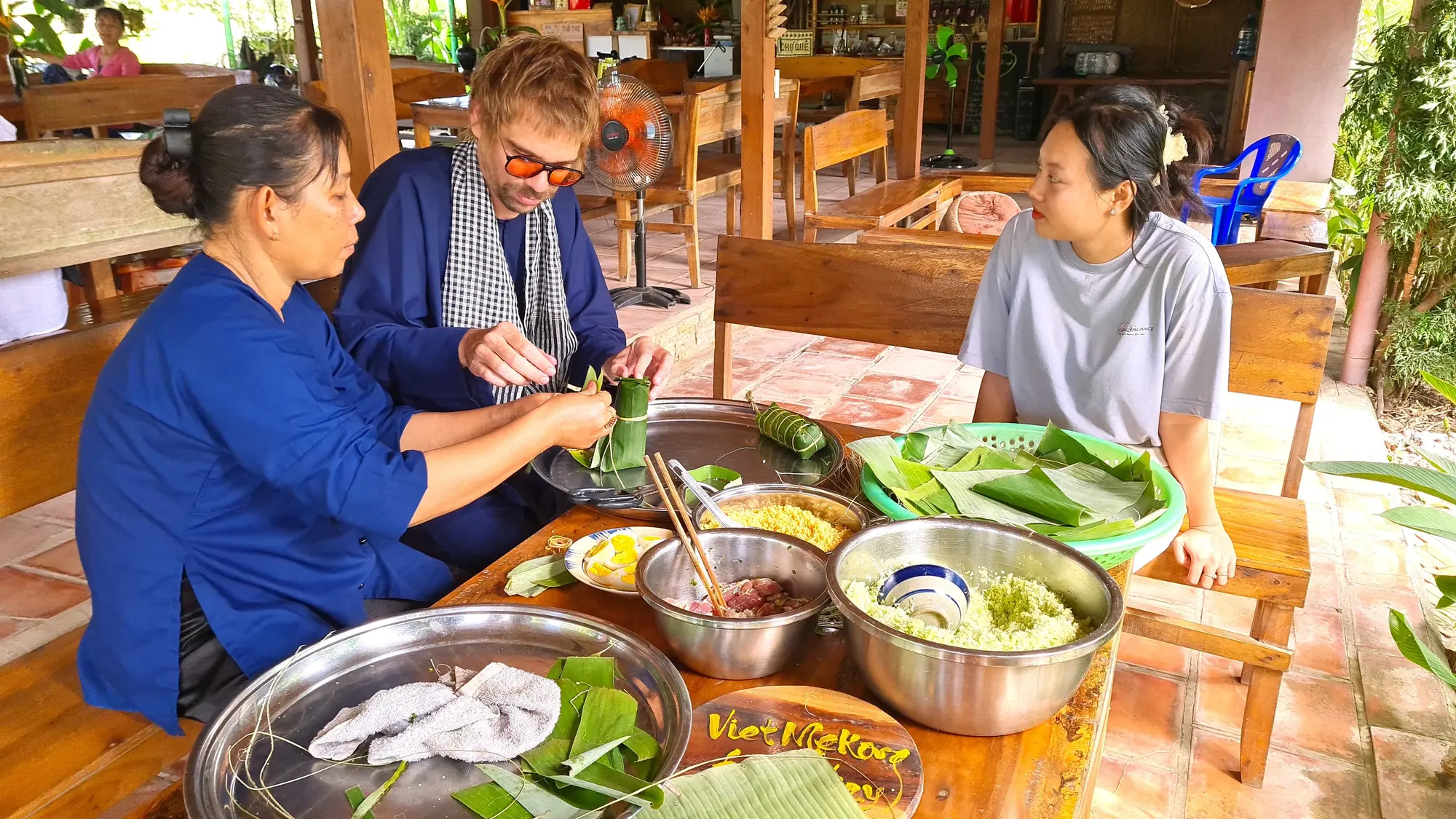 Guests and local hosts preparing seasonal food together