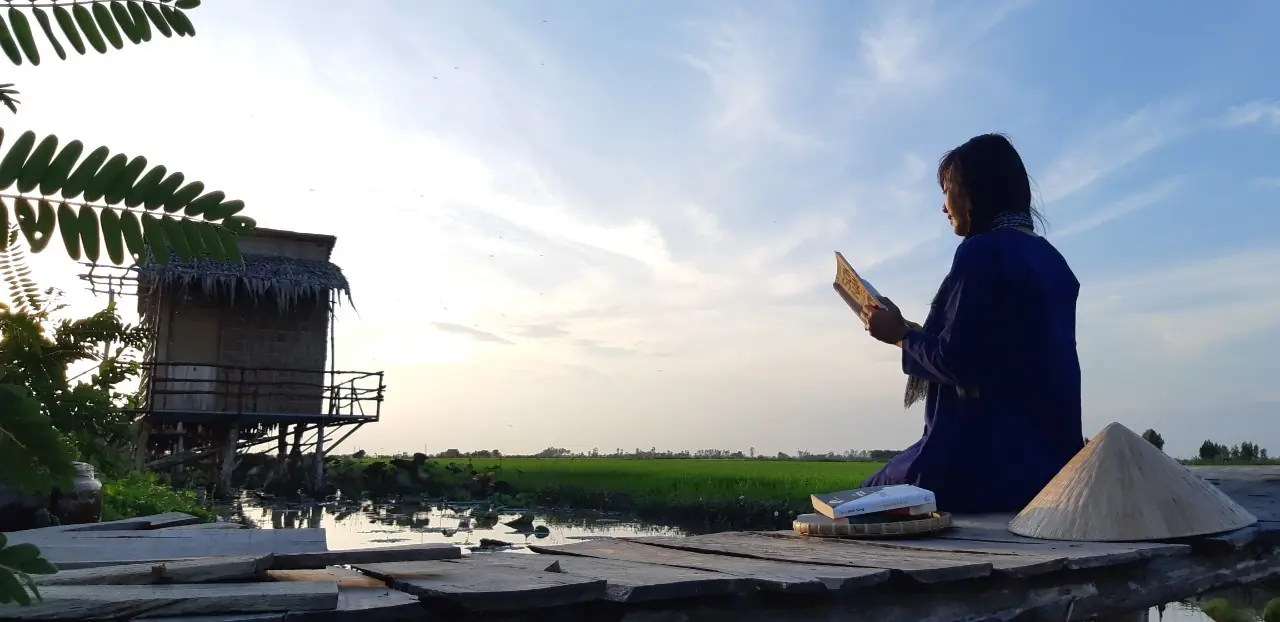 A guest reading quietly beside the wetland