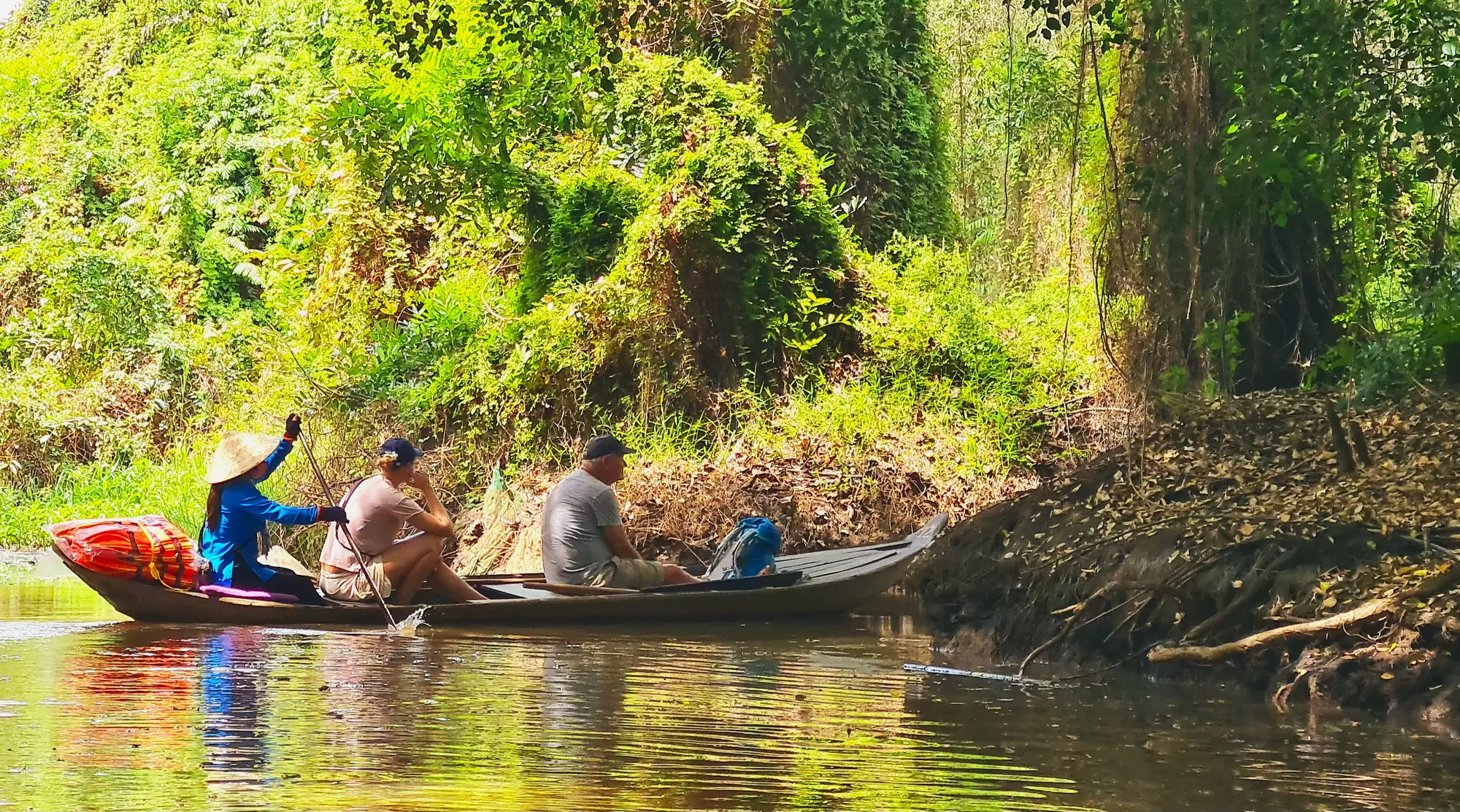 Guests moving quietly by canoe through a rural waterway
