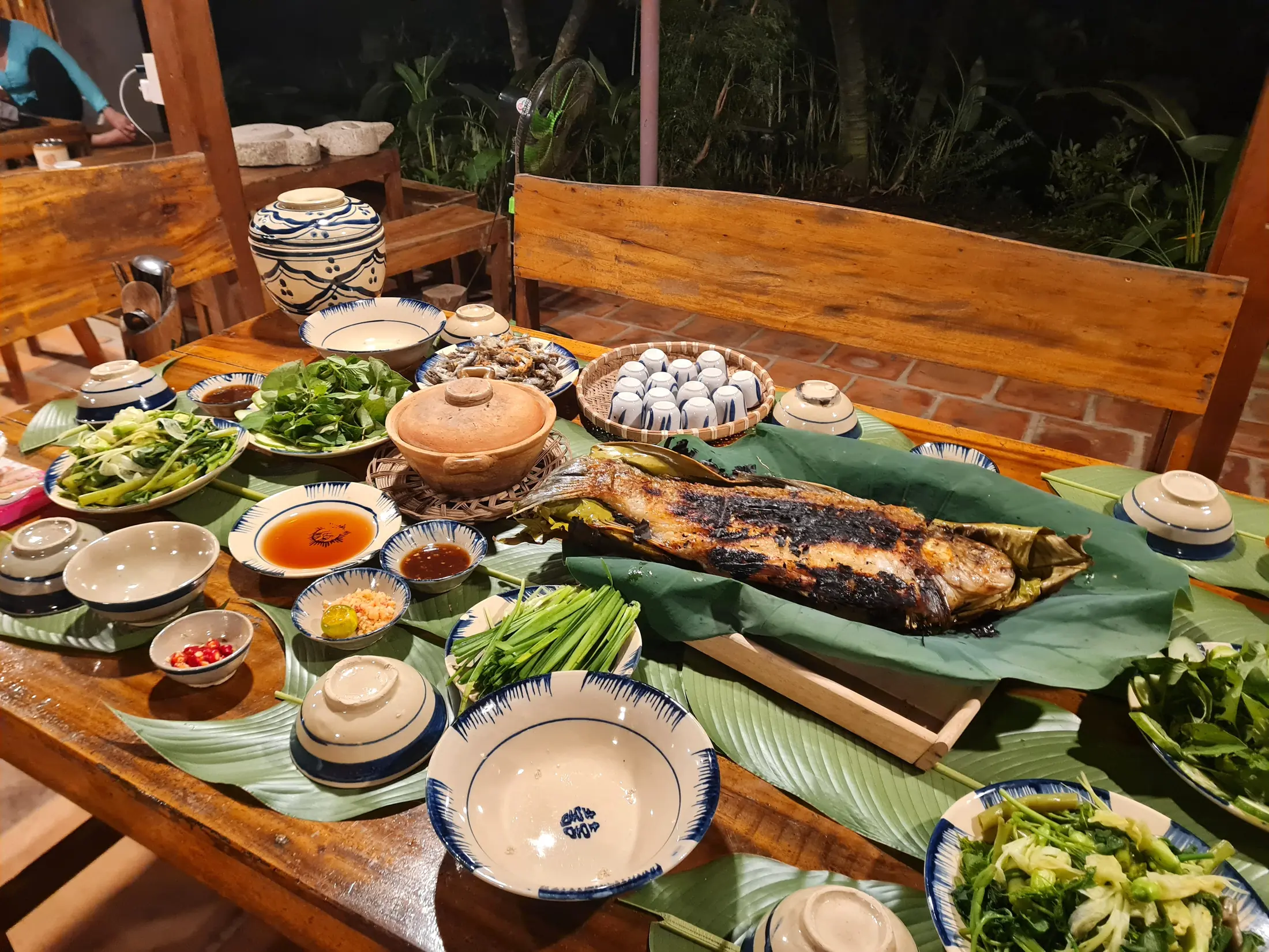 A shared fish and vegetable meal on the farmstay table