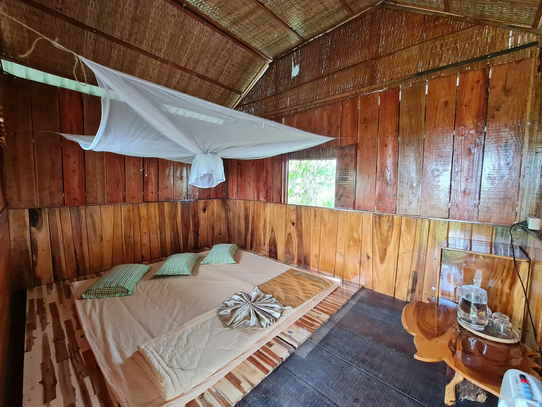 Eco Stilt House bedroom with mosquito netting